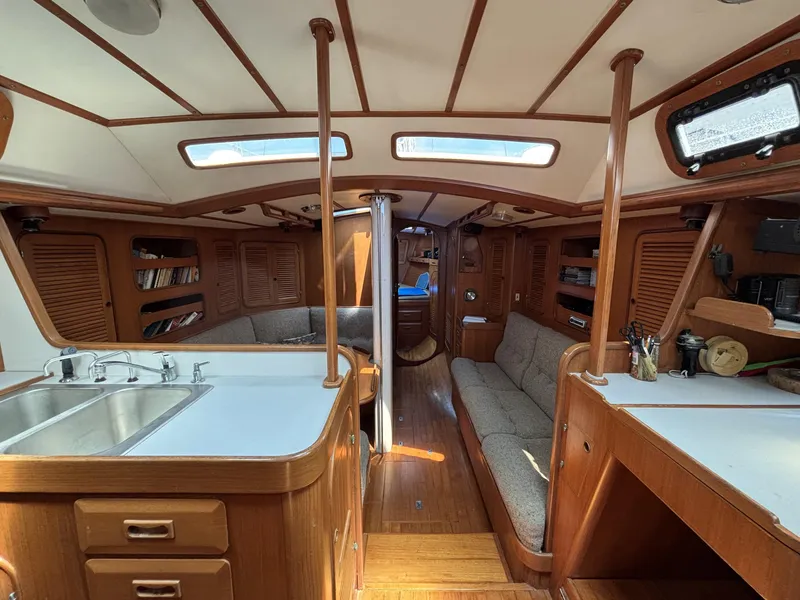 Interior of 1982 Norseman 447 sailboat with wood finish and cozy seating area.