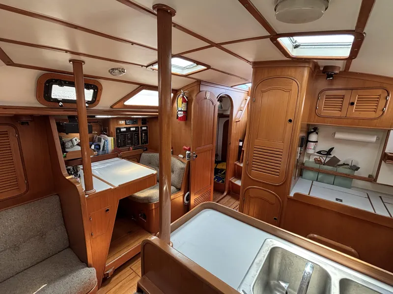 Interior of 1982 Norseman 447 sailboat, featuring wood paneling and compact living space.