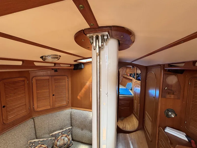 Interior of 1982 Norseman 447 sailboat with wooden paneling and cozy seating area.