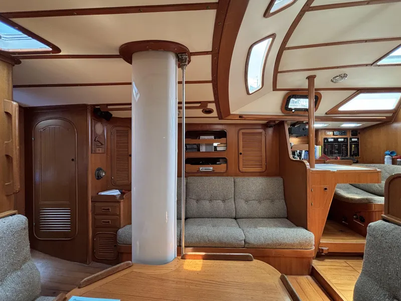 Interior of 1982 Norseman 447 sailboat with wooden furnishings and cozy seating.