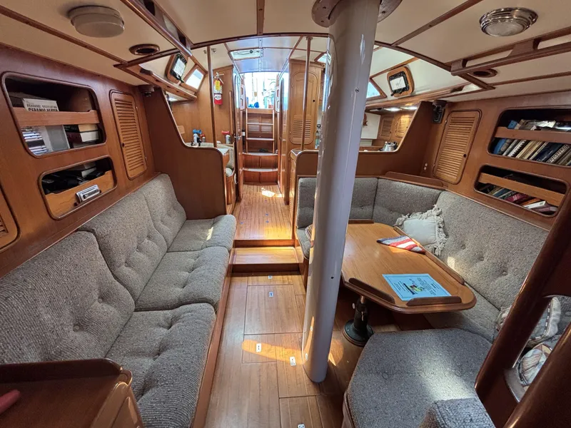 Interior of 1982 Norseman 447 sailboat with cozy seating and wooden finishes.
