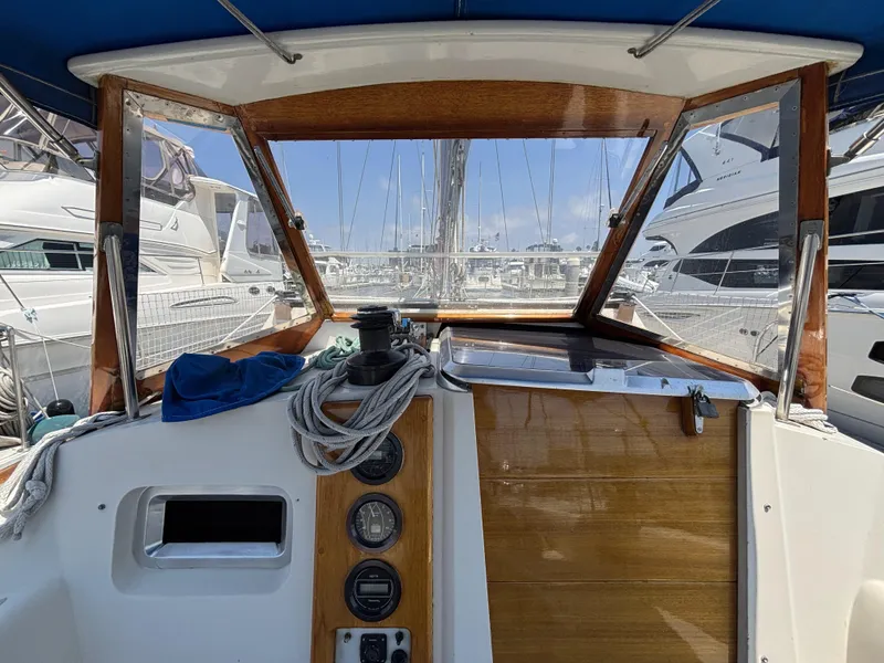 Cockpit view of 1982 Norseman 447 sailboat, featuring wooden paneling and nautical equipment.