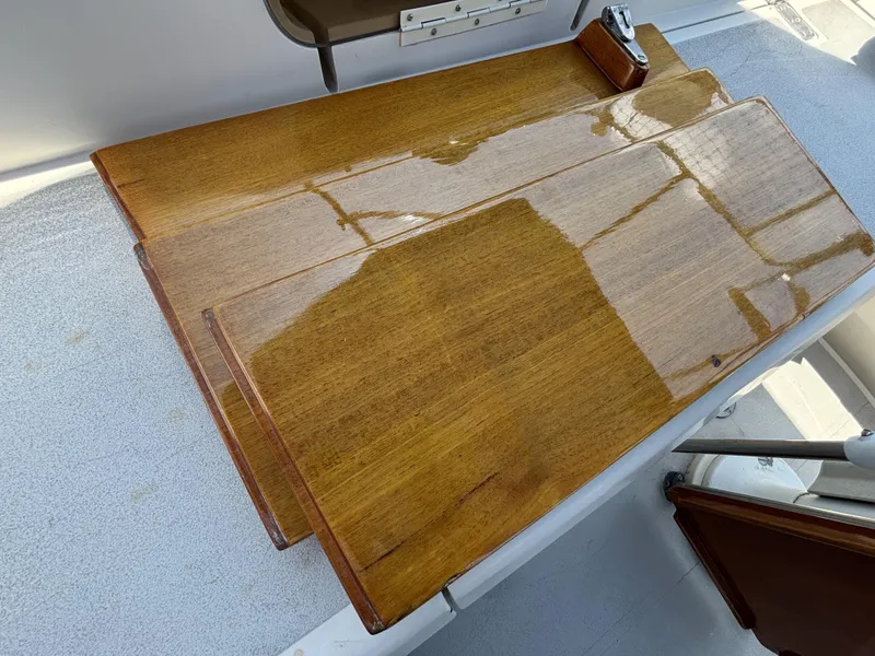 Polished wooden table on a 1982 Norseman 447 boat deck.