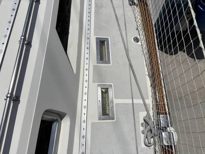 Deck of 1982 Norseman 447 sailboat with metal fixtures and safety netting.
