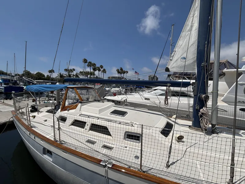 1982 Norseman 447 sailboat docked at marina under clear blue sky.