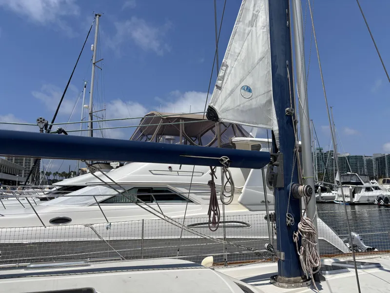 Sailboat Norseman 447, 1982 model, docked in marina with clear blue sky.