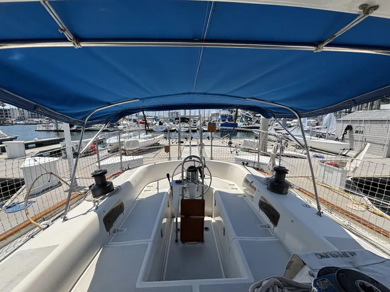 Cockpit view of 1982 Norseman 447 sailboat with blue canopy at marina.