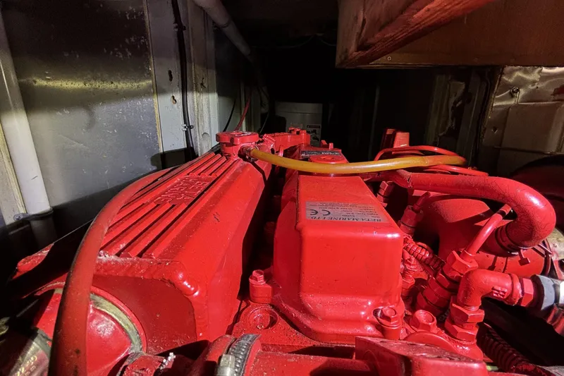 Red engine of a 1982 Norseman 447, showcasing intricate mechanical components.