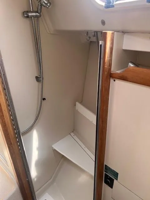Interior shower area of a 2002 Catalina 350 sailboat with wooden accents.