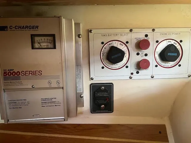 Electrical control panel on a 2002 Catalina 350 boat, featuring battery selectors and a charger.