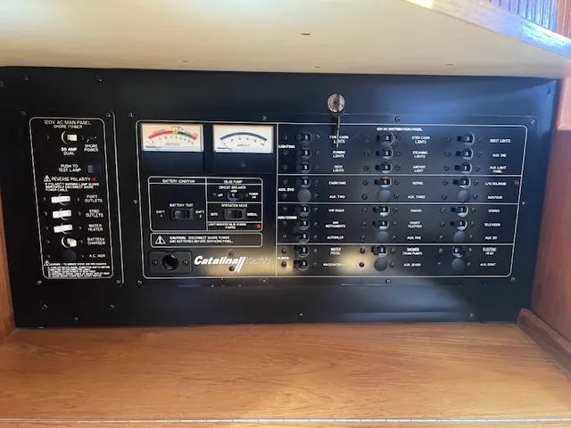 Electrical control panel of a 2002 Catalina 350 sailboat, featuring gauges and switches.