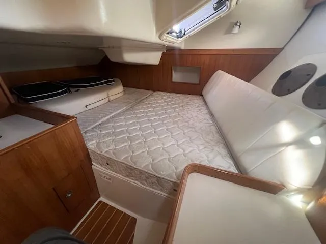 Interior cabin of a 2002 Catalina 350 sailboat with a comfortable bed.