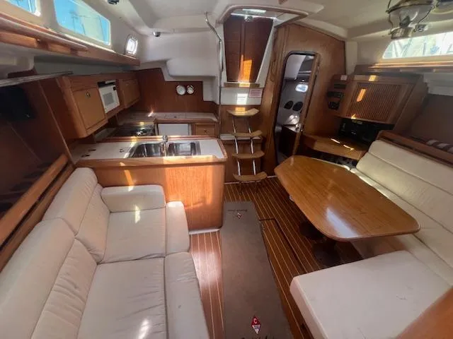 Interior of a 2002 Catalina 350 sailboat with kitchen and seating area.