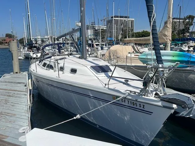 2002 Catalina 350 sailboat docked at marina, surrounded by other boats.