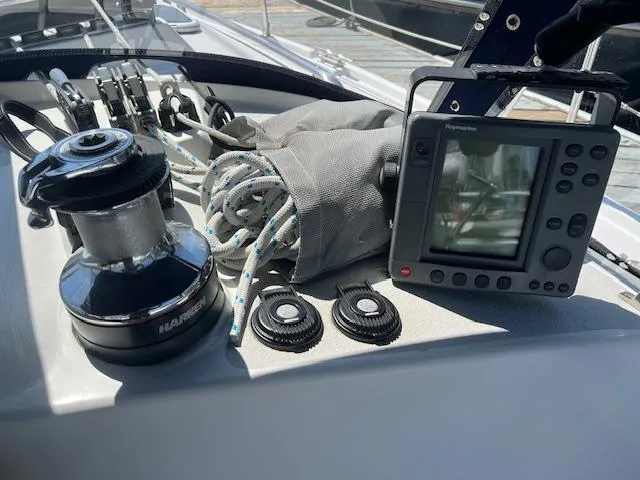 Sailing equipment on a 2002 Catalina 350 yacht, featuring winch, ropes, and navigation display.