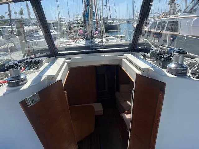 2002 Catalina 350 sailboat cockpit with open cabin doors, docked at a marina.