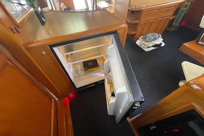 Interior of 1990 Offshore Yachts 55 Pilothouse with open mini fridge.