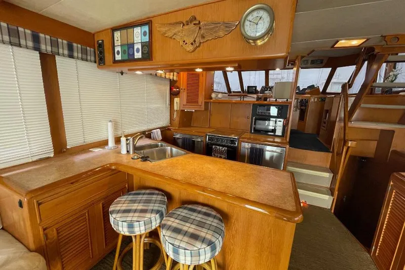 Interior of 1990 Offshore Yachts 55 Pilothouse with kitchen and seating area.