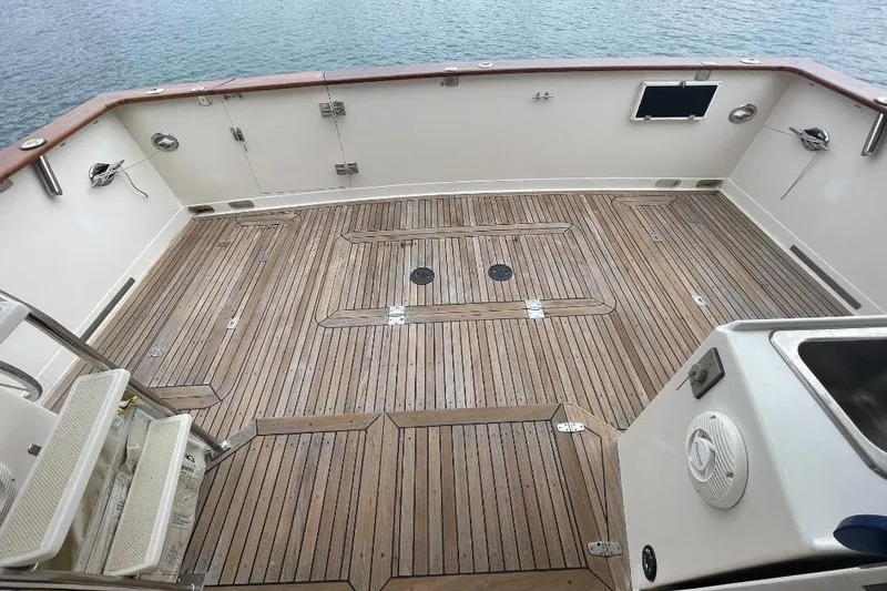1990 Offshore Yachts 55 Pilothouse deck with teak flooring and ocean view.