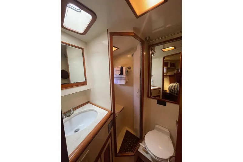 Bathroom interior of 1990 Offshore Yachts 55 Pilothouse with sink and toilet.