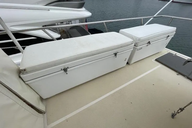 1990 Offshore Yachts 55 Pilothouse deck with white storage benches.