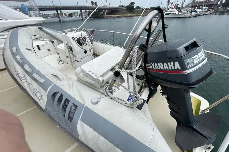 Inflatable boat with Yamaha 25 outboard motor on 1990 Offshore Yachts 55 Pilothouse.