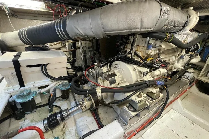 Engine room of a 1990 Offshore Yachts 55 Pilothouse, showcasing mechanical components.