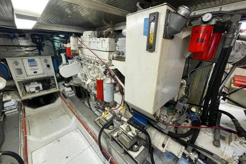 Engine room of a 1990 Offshore Yachts 55 Pilothouse, showcasing machinery and equipment.