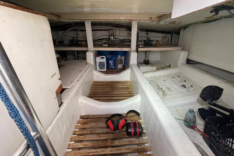 Engine room of 1990 Offshore Yachts 55 Pilothouse with equipment and tools.
