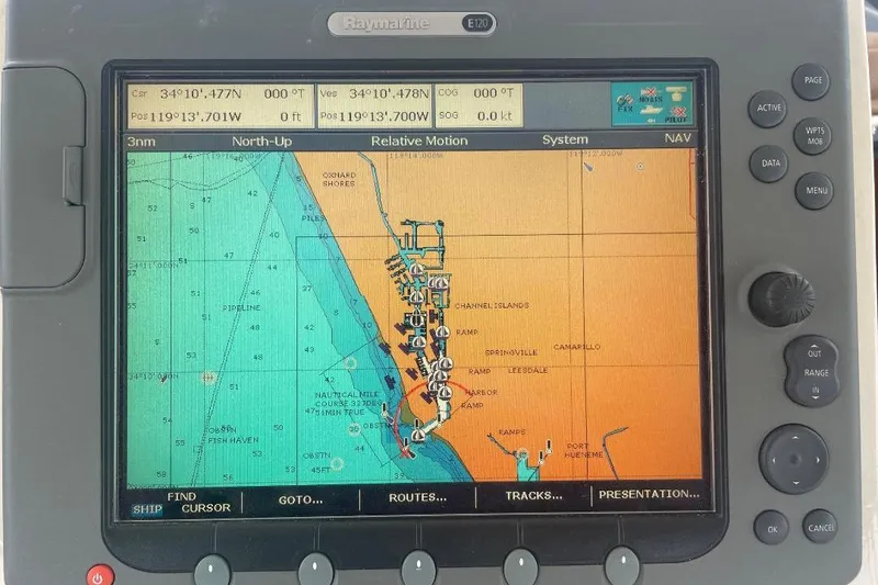 Raymarine navigation display on 1990 Offshore Yachts 55 Pilothouse, showing nautical chart and coordinates.