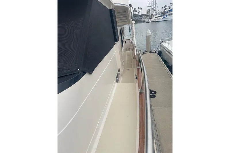 Side view of 1990 Offshore Yachts 55 Pilothouse docked at marina.