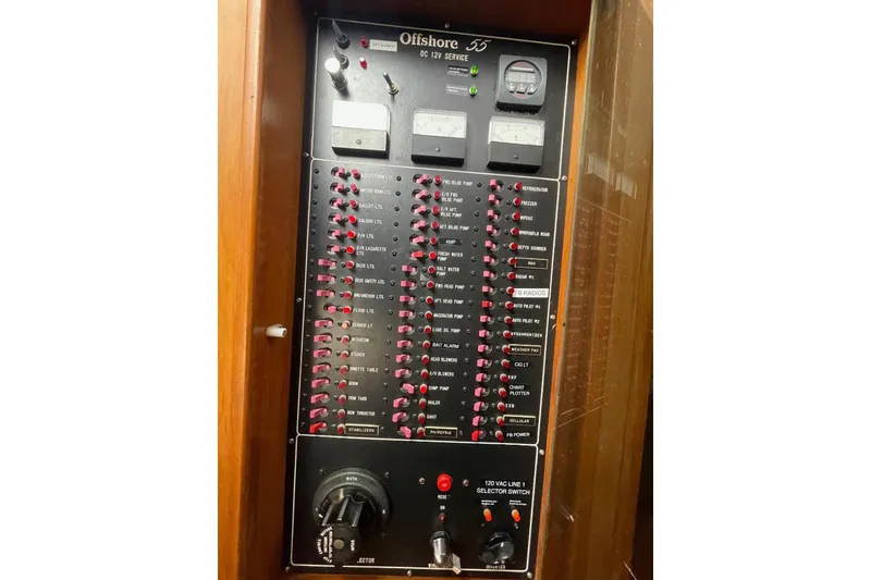 Electrical panel of 1990 Offshore Yachts 55 Pilothouse, featuring various switches and gauges.