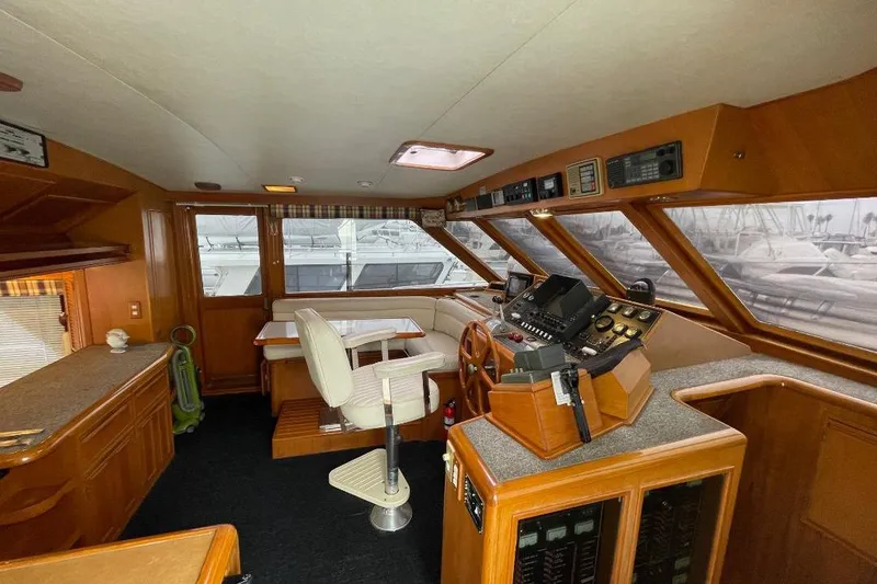 1990 Offshore Yachts 55 Pilothouse interior with helm, seating, and navigation equipment.