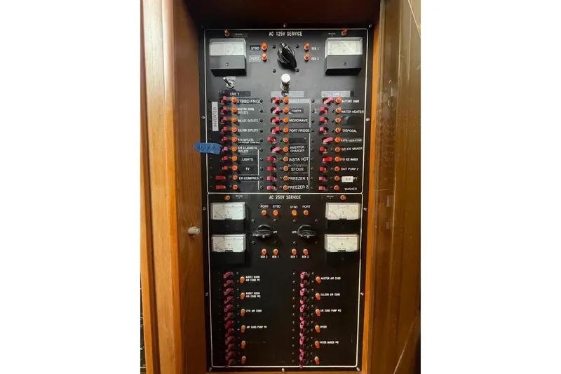 Electrical panel of a 1990 Offshore Yachts 55 Pilothouse, featuring various switches and meters.