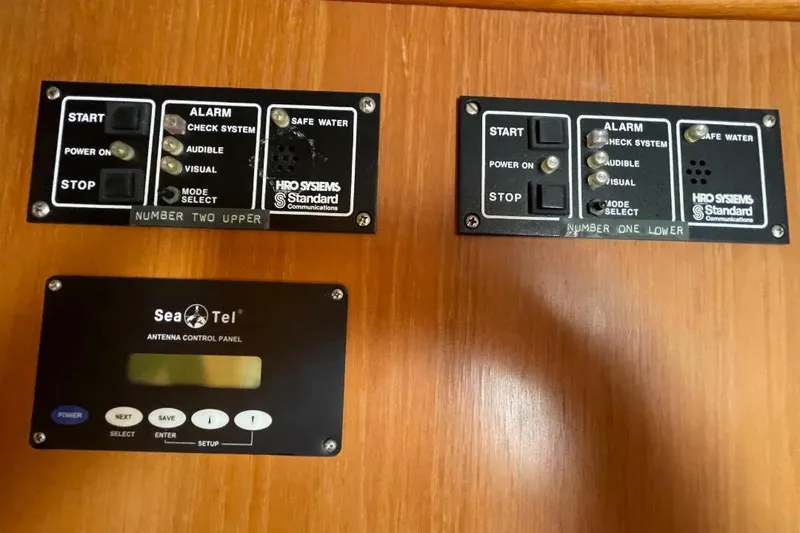 Control panels on a 1990 Offshore Yachts 55 Pilothouse, featuring alarm and antenna systems.