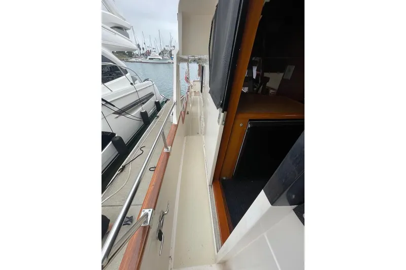 1990 Offshore Yachts 55 Pilothouse side deck view at marina.