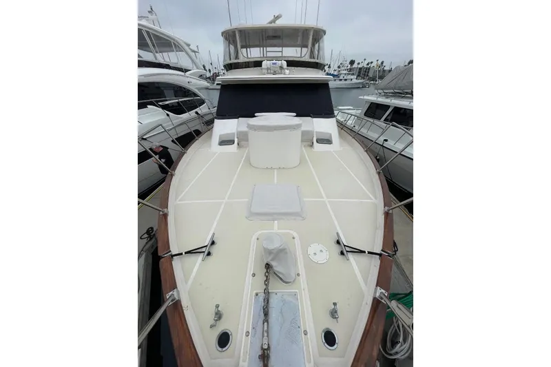 1990 Offshore Yachts 55 Pilothouse, docked, showcasing spacious deck and pilothouse.