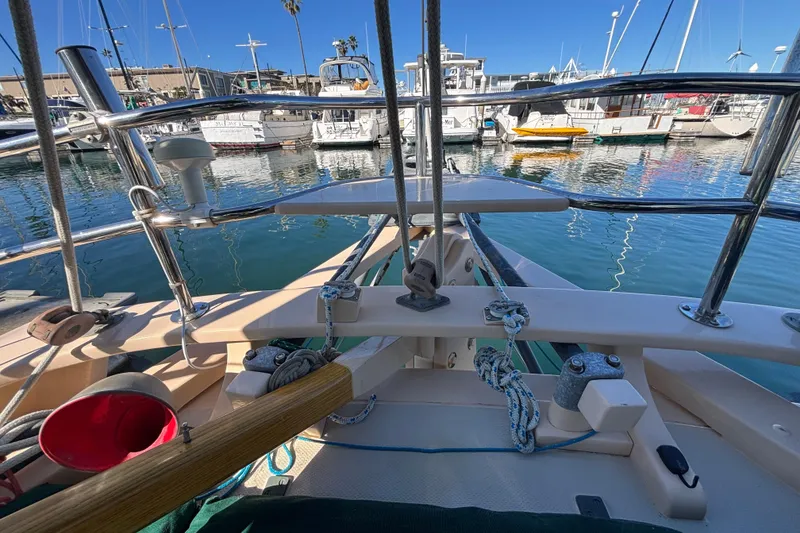 1983 Bristol Channel Cutter 28 sailboat docked in a marina, featuring deck and rigging details.
