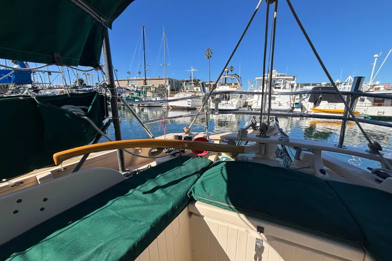 1983 Bristol Channel Cutter 28 sailboat docked in a sunny marina.