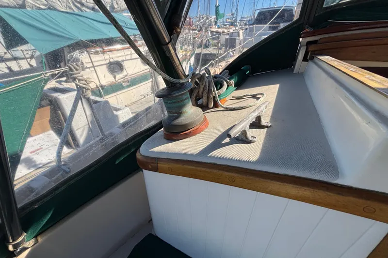 1983 Bristol Channel Cutter 28 sailboat deck with winch and cleat in marina.