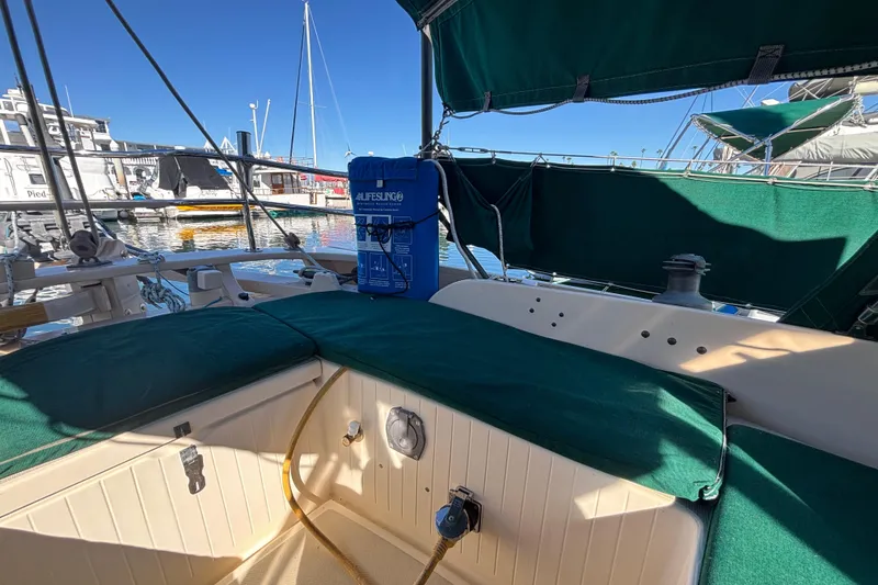1983 Bristol Channel Cutter 28 sailboat interior with green upholstery at a marina.