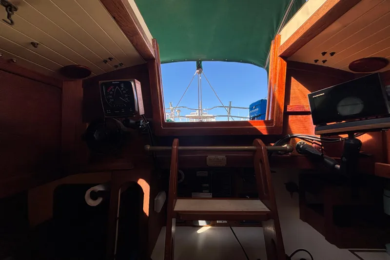 Interior view of 1983 Bristol Channel Cutter 28 sailboat cockpit with navigation instruments.