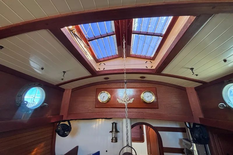Interior of 1983 Bristol Channel Cutter 28 with wooden finish and skylight.