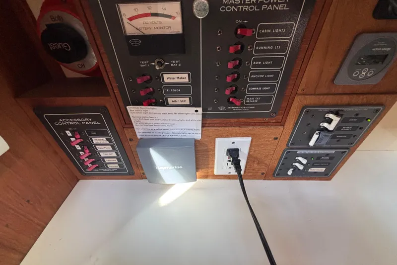 Control panel of a 1983 Bristol Channel Cutter 28 with various switches and gauges.