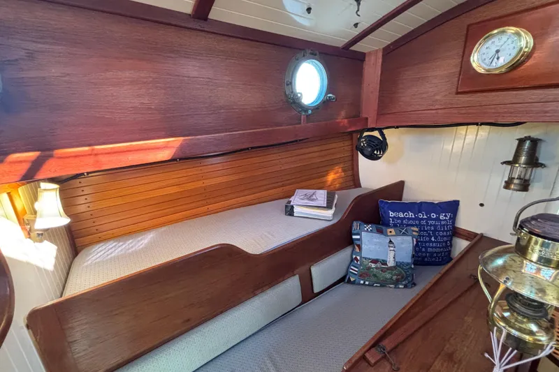 Cozy 1983 Bristol Channel Cutter 28 cabin interior with wooden finish and nautical decor.