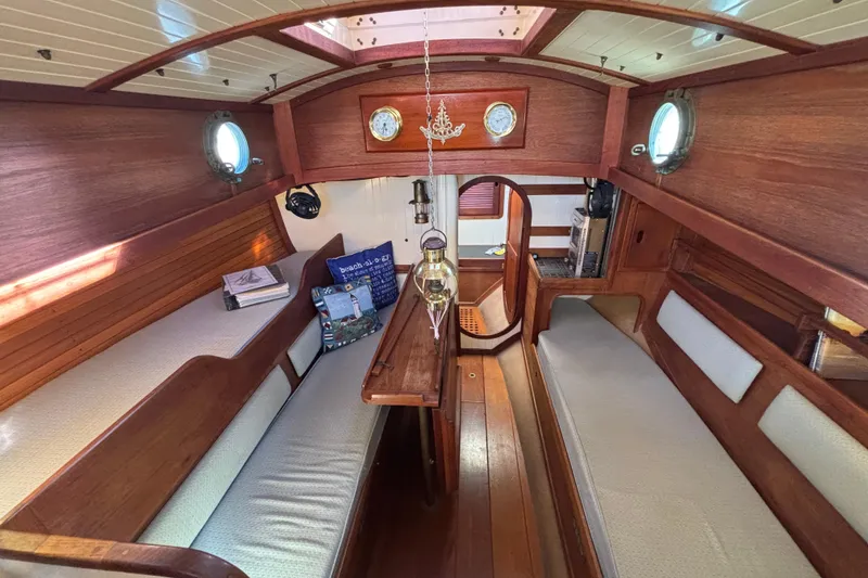 Interior of 1983 Bristol Channel Cutter 28, featuring wooden finishes and cozy seating.
