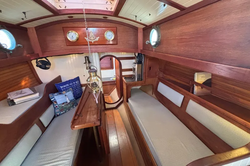 Interior of 1983 Bristol Channel Cutter 28, featuring wooden finish and cozy seating.