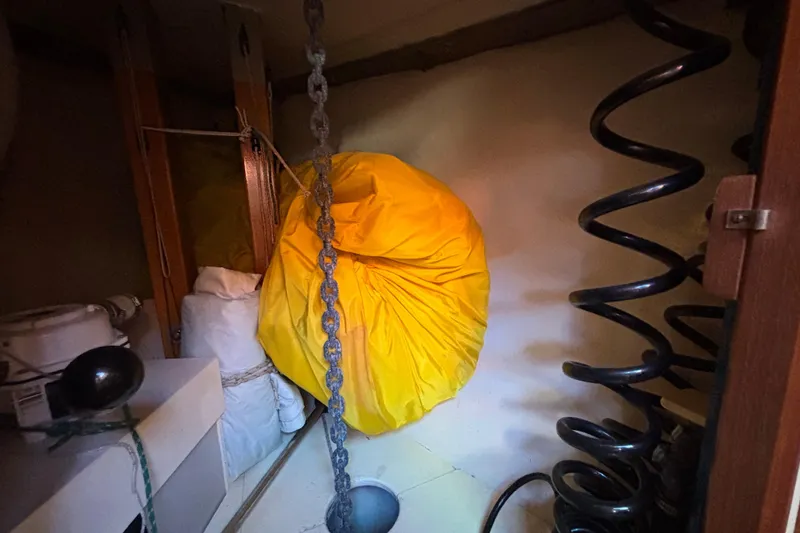 Interior of 1983 Bristol Channel Cutter 28 with yellow bag and coiled chain.