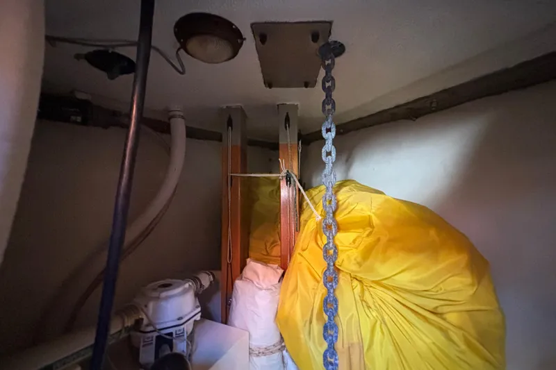 Interior of 1983 Bristol Channel Cutter 28 with chain and yellow sail bag.