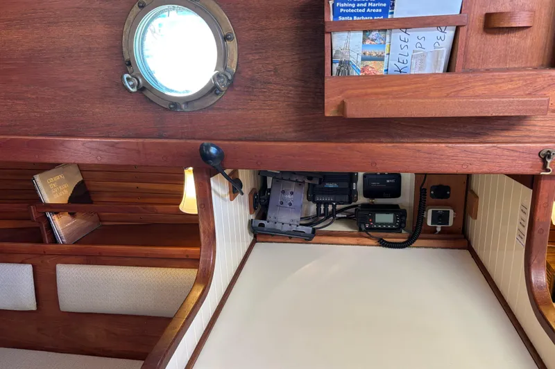 Interior of 1983 Bristol Channel Cutter 28, featuring navigation equipment and wooden cabinetry.
